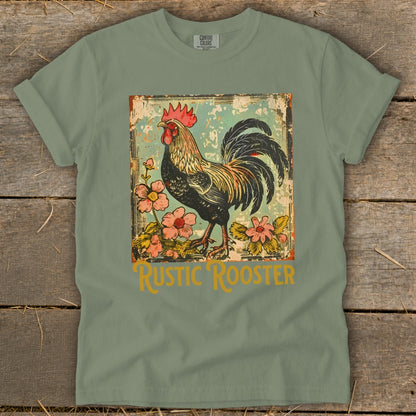 Green t-shirt with a distressed graphic of a rooster and pink flowers, reads "Rustic Rooster."