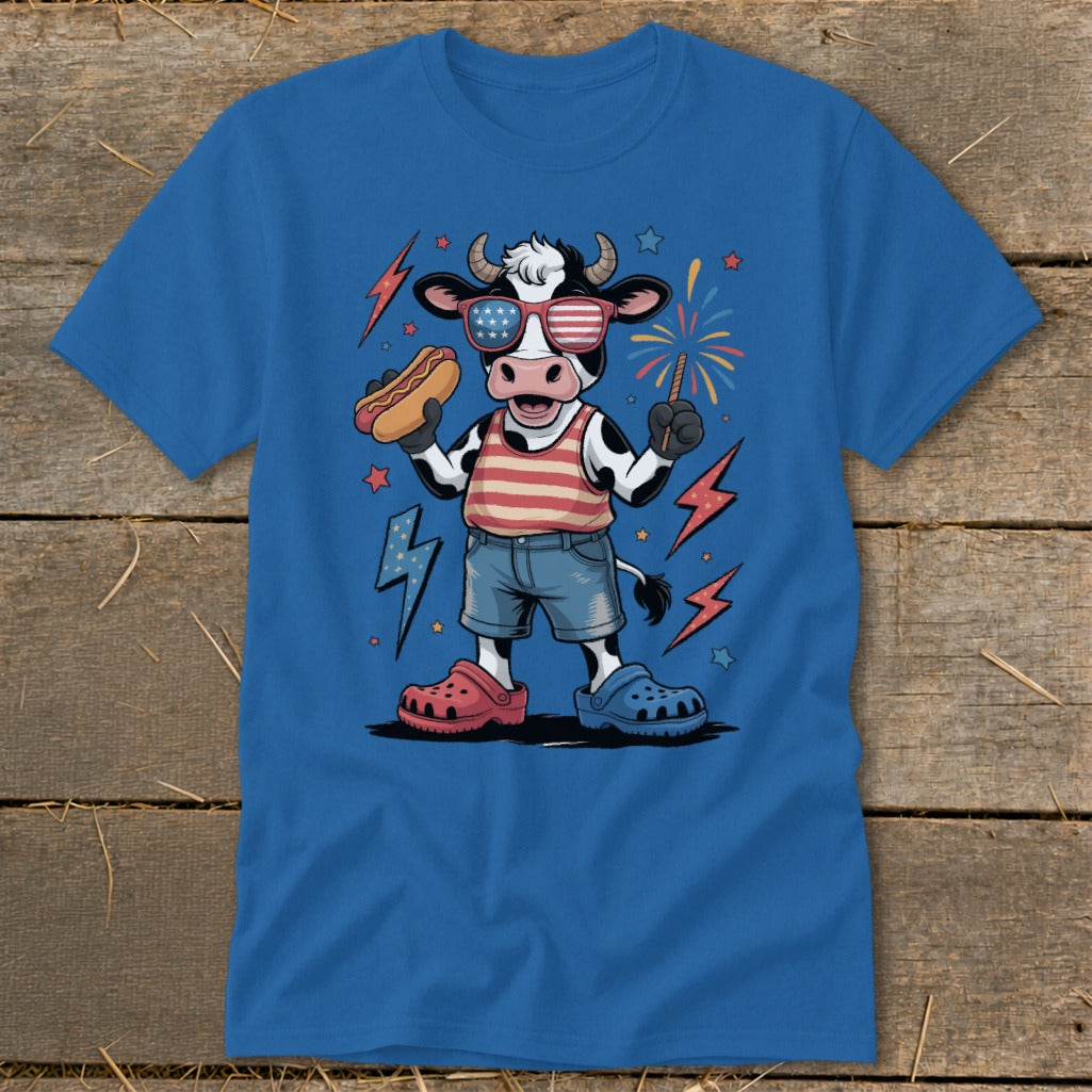 Cartoon cow in patriotic attire holding a hot dog and sparkler.