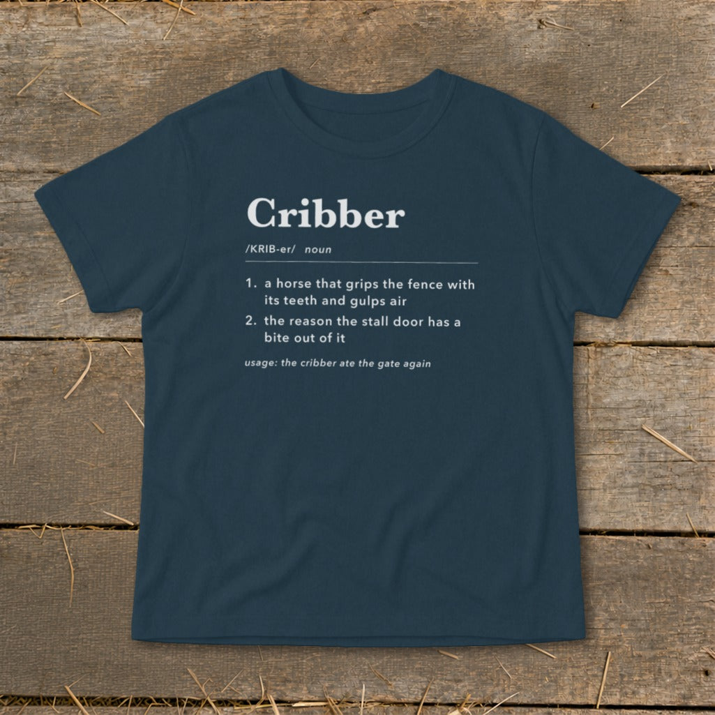 A dark blue t-shirt printed with a humorous dictionary definition of the word cribber.