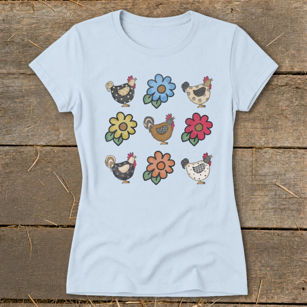 Light blue t-shirt with a pattern of cartoon chickens and flowers.