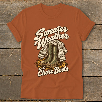 Orange t-shirt graphic with "Sweater Weather and Chore Boots" text, boots, and sweater.