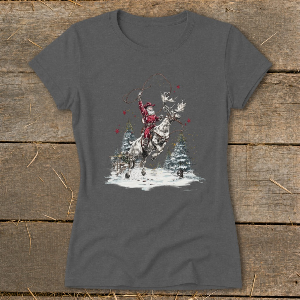 Santa riding a reindeer with lasso in a snowy winter scene with pine trees.