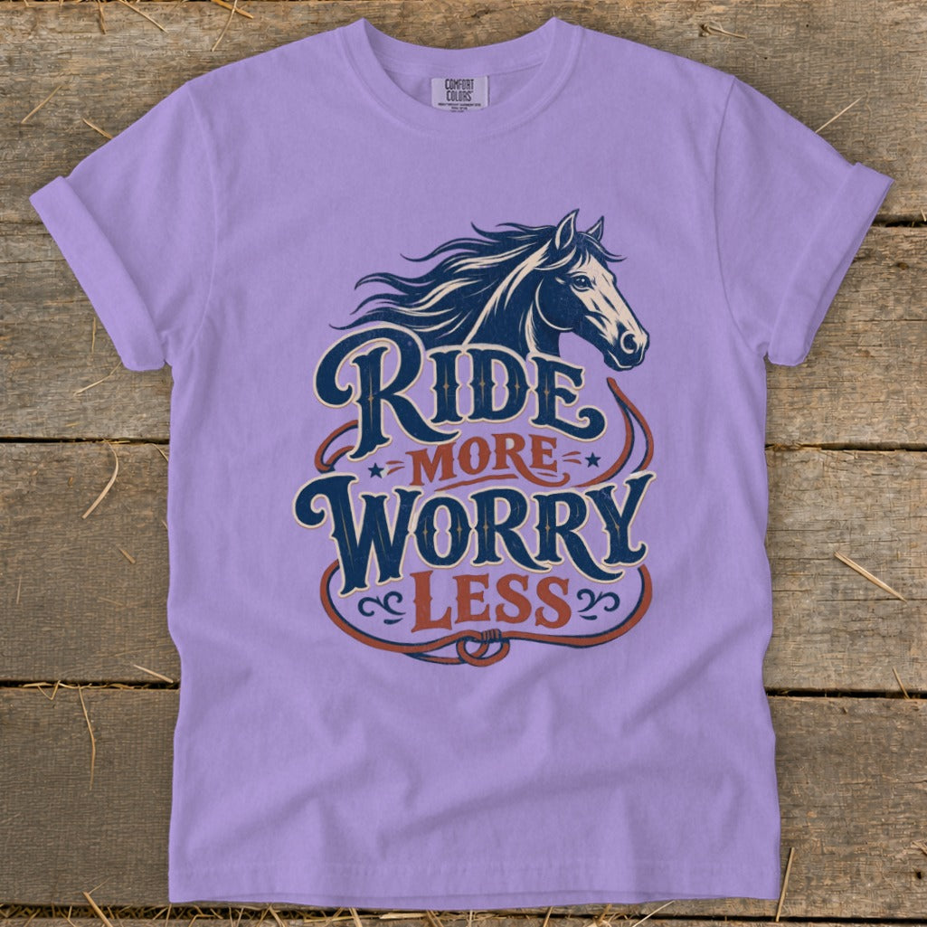 Purple t-shirt with a graphic of a horse and the text "Ride More Worry Less".