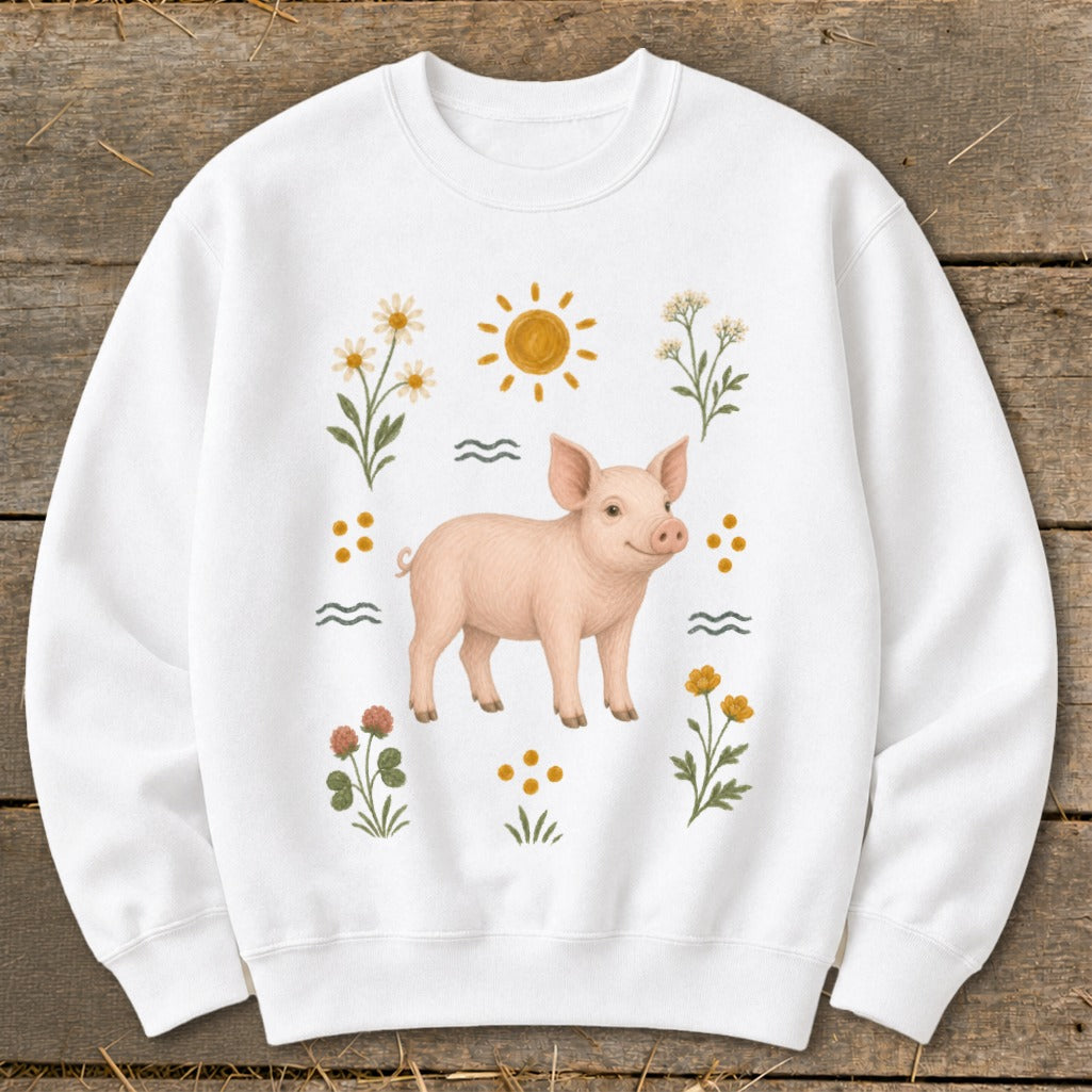 White sweatshirt with a pink piglet and floral sun graphic.