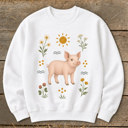 White sweatshirt with a pink piglet and floral sun graphic.