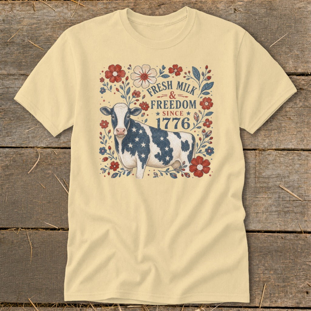 Yellow t-shirt with a patriotic cow and "Fresh Milk & Freedom Since 1776" text.