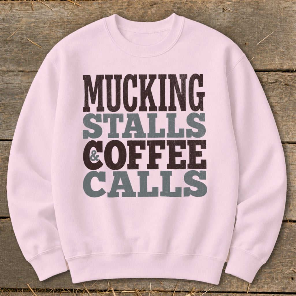 Pink sweatshirt with "Mucking Stalls & Coffee Calls" text in distressed grey and brown.