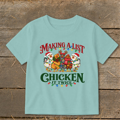 Light blue t-shirt with chickens in Santa hats and Christmas lights, "Making a list, chicken it twice" text.