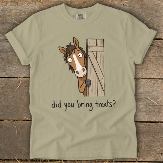 Tan t-shirt with cartoon horse peeking from a wooden gate asking "did you bring treats?"