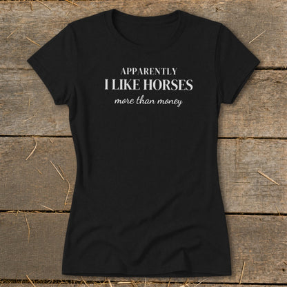 Black t-shirt with white text: "APPARENTLY I LIKE HORSES more than money"