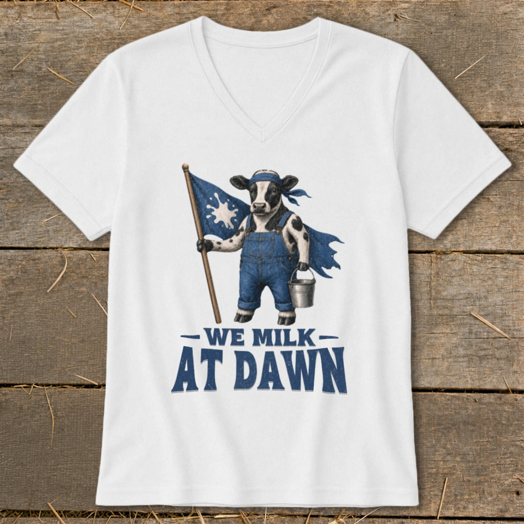 White t-shirt with graphic of a cow in overalls holding a flag and bucket, reads "We Milk At Dawn."