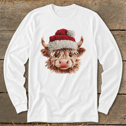 White long-sleeve shirt with a Christmas Highland cow graphic on the chest.