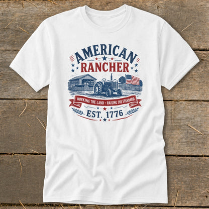 White t-shirt with "American Rancher" graphic, tractor, barn, and American flag.