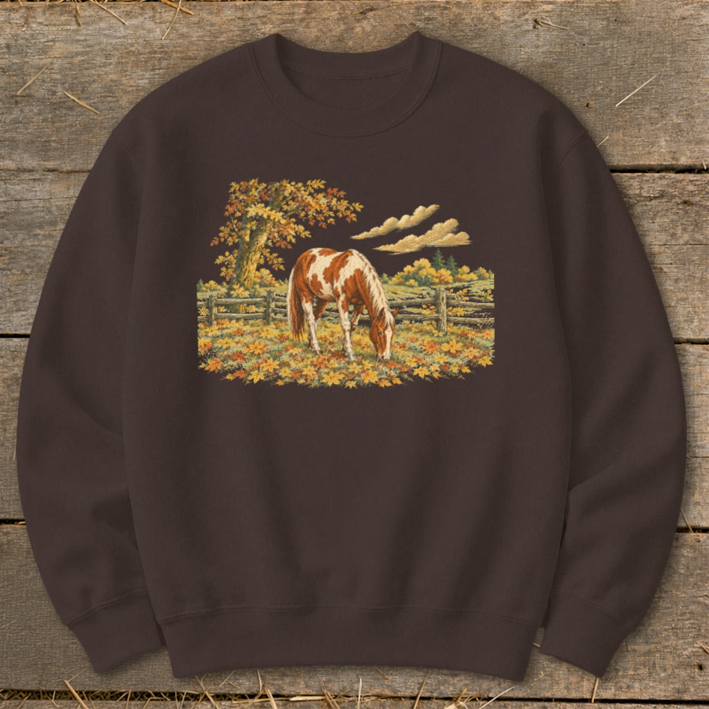 Brown sweatshirt with a pinto horse grazing in a fall field.