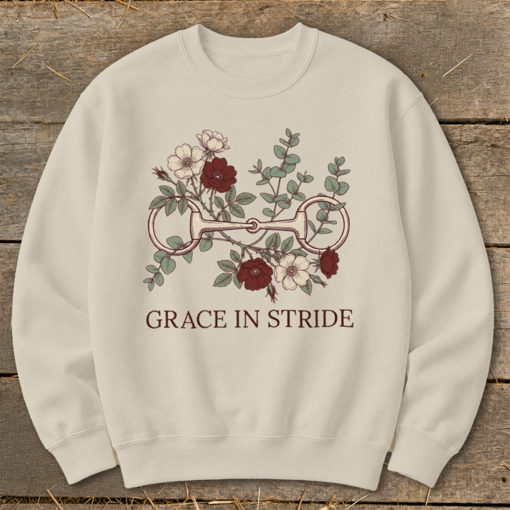Cream sweatshirt with equestrian bit and floral design, text "GRACE IN STRIDE".