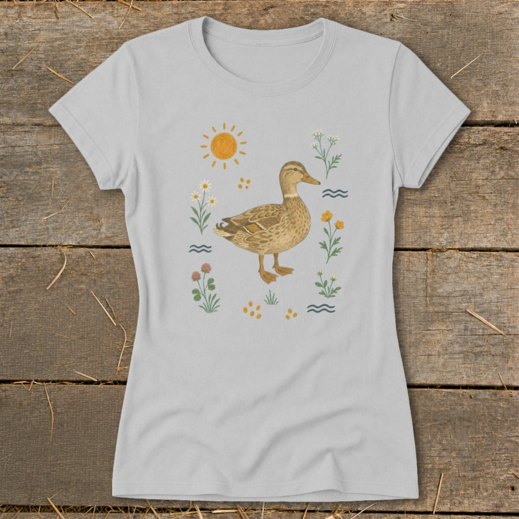 Light gray t-shirt with a watercolor duck surrounded by flowers, sun, and waves.