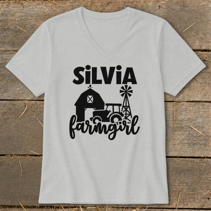 Light grey v-neck t-shirt with black farm graphic and "Silvia farmingirl" text.