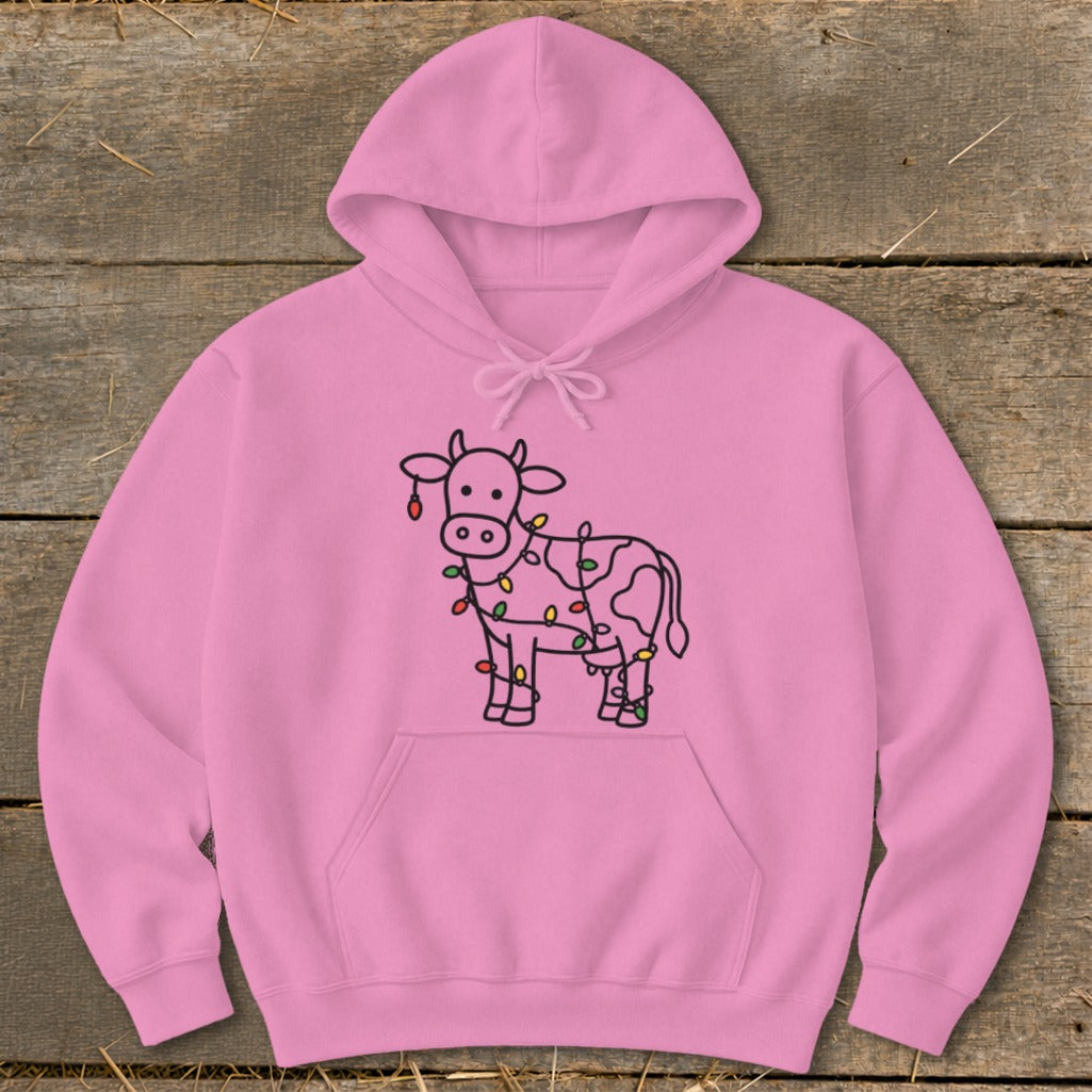 Pink hoodie with a black outline drawing of a cow decorated with colorful Christmas lights.