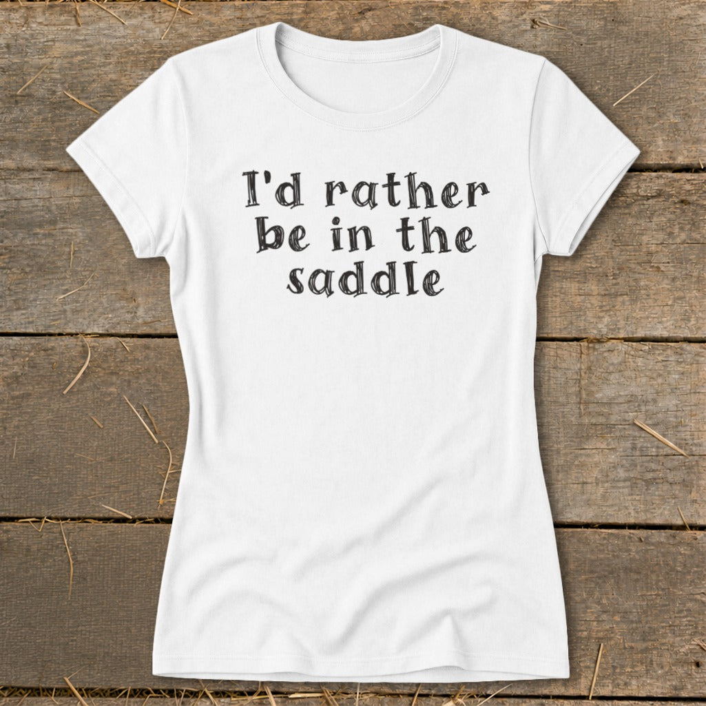 White t-shirt with black text that reads "I'd rather be in the saddle."