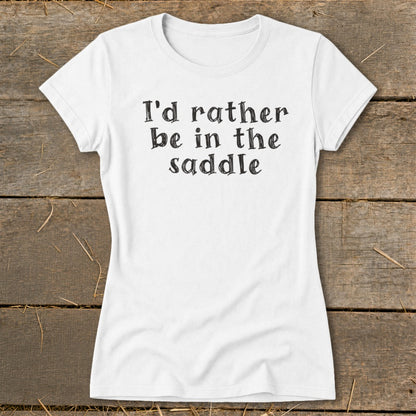 White t-shirt with black text that reads "I'd rather be in the saddle."