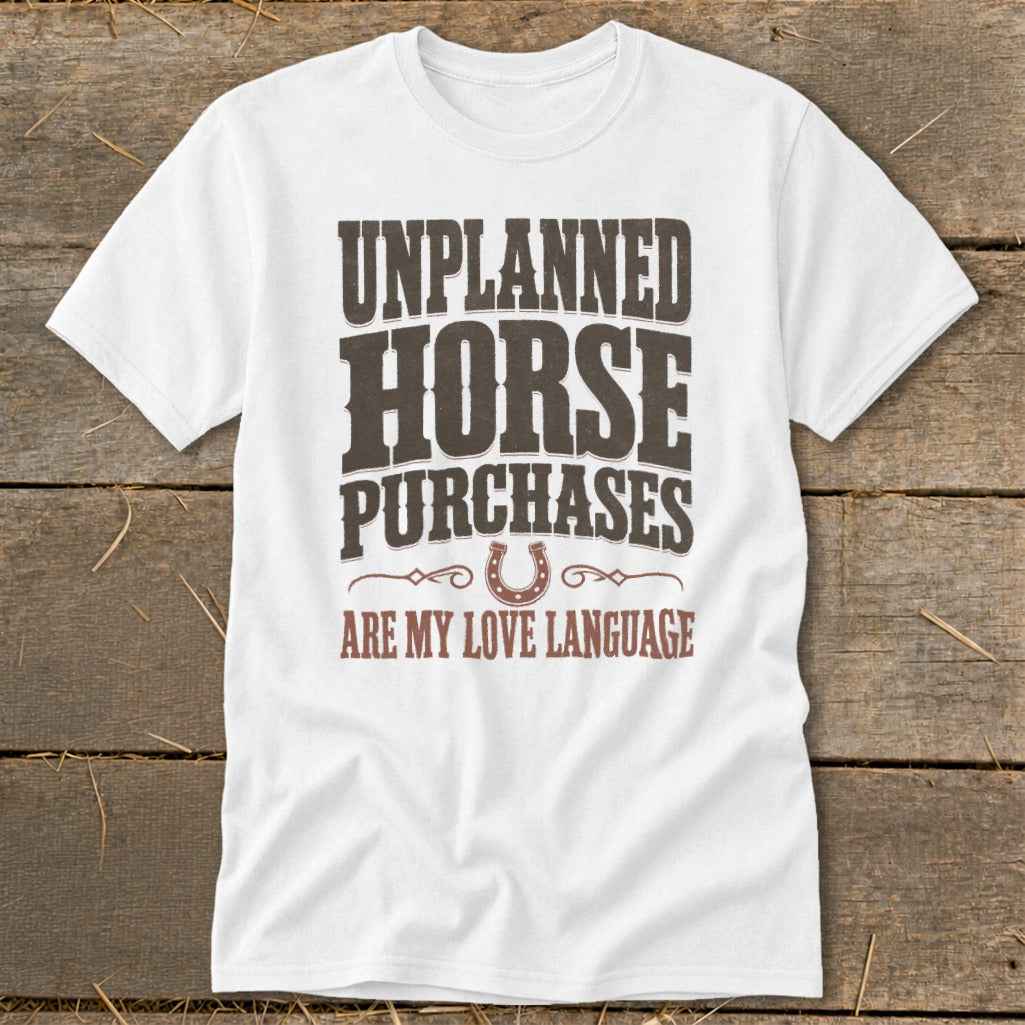 White t-shirt with text "UNPLANNED HORSE PURCHASES ARE MY LOVE LANGUAGE" and a horseshoe graphic.