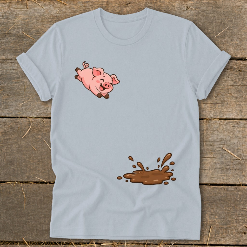 Light blue t-shirt with a cartoon pig jumping above a brown mud splash.
