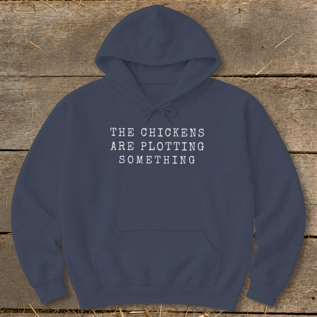 Navy hoodie with white text "The Chickens Are Plotting Something."