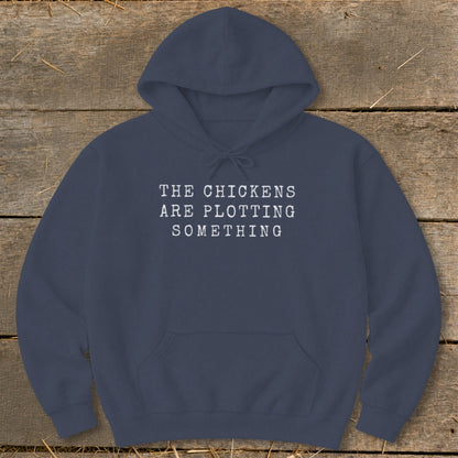 Navy hoodie with white text "The Chickens Are Plotting Something."