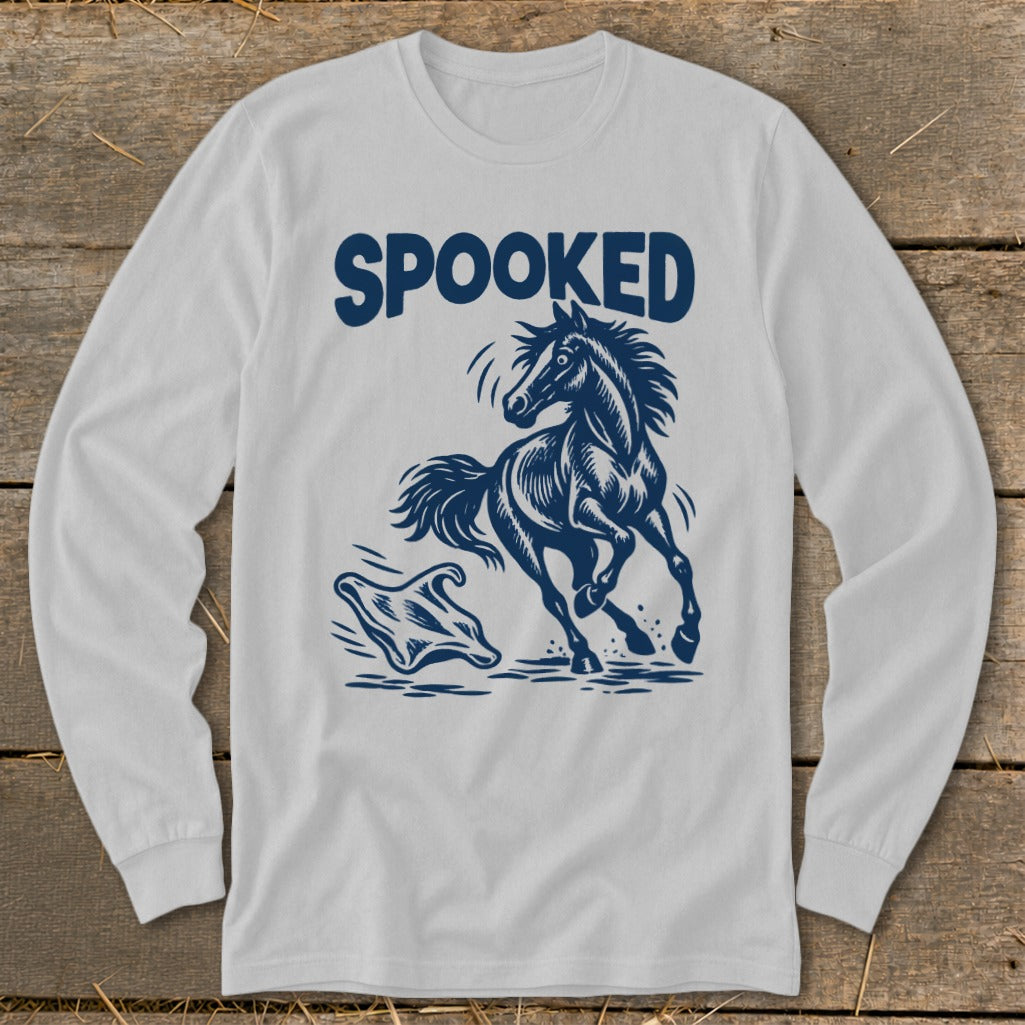 White long-sleeve shirt with navy blue graphic of a running horse and ghost, text reads SPOOKED.