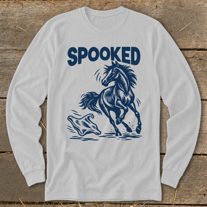 White long-sleeve shirt with navy blue graphic of a running horse and ghost, text reads SPOOKED.