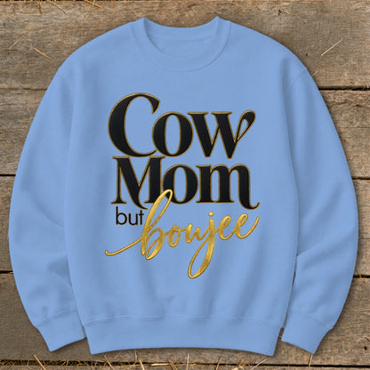 Light blue sweatshirt with "Cow Mom but Boujee" text in black and gold lettering.