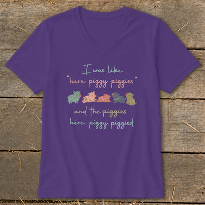 Purple t-shirt with quote "I was like 'here piggy piggies' and the piggies here piggy piggied" and cartoon pigs.