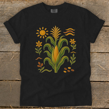 Black t-shirt with a corn stalk and sun graphic, bordered by flowers and leaves.