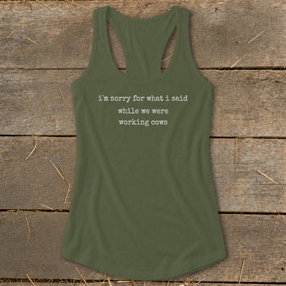 Olive green racerback tank top with white text reading "i'm sorry for what i said while we were working cows".