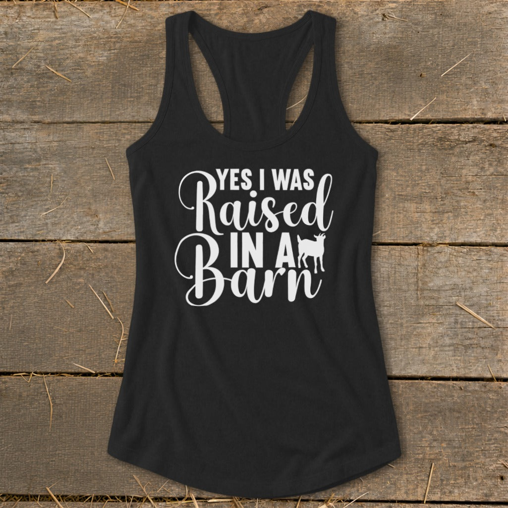 Black tank top with white text that reads "Yes I Was Raised In A Barn" and a goat silhouette.