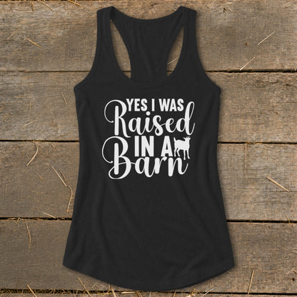Black tank top with white text that reads "Yes I Was Raised In A Barn" and a goat silhouette.