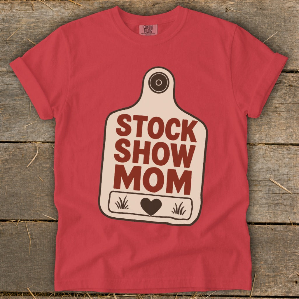 Red t-shirt with a stock tag graphic that says "STOCK SHOW MOM" with a heart.