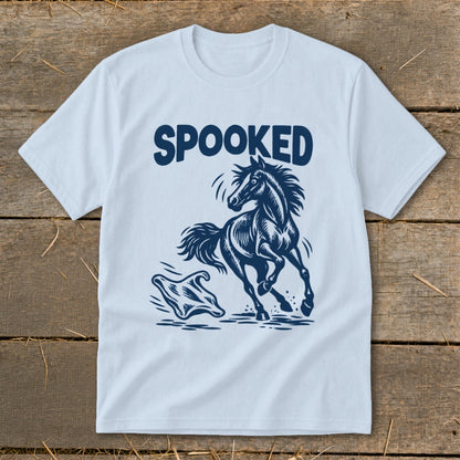 Light blue t-shirt with "SPOOKED" text above a startled horse and a ghost graphic.