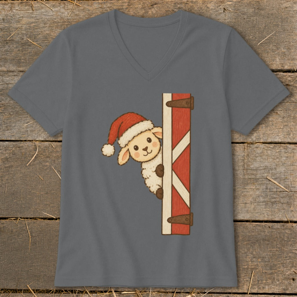 Sheep wearing a Santa hat peeking from behind a barn door.