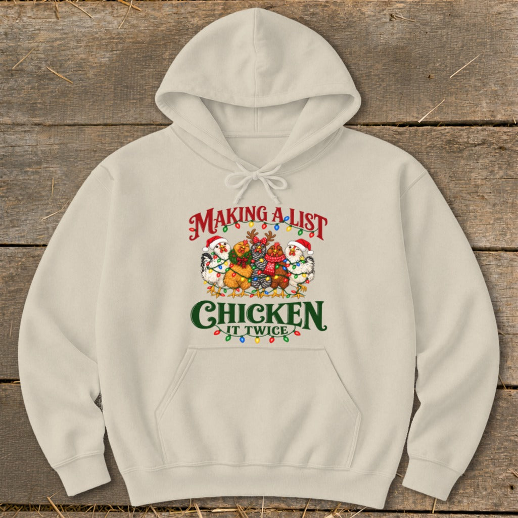 Beige hoodie with festive chickens and text "Making a list, chicken it twice".