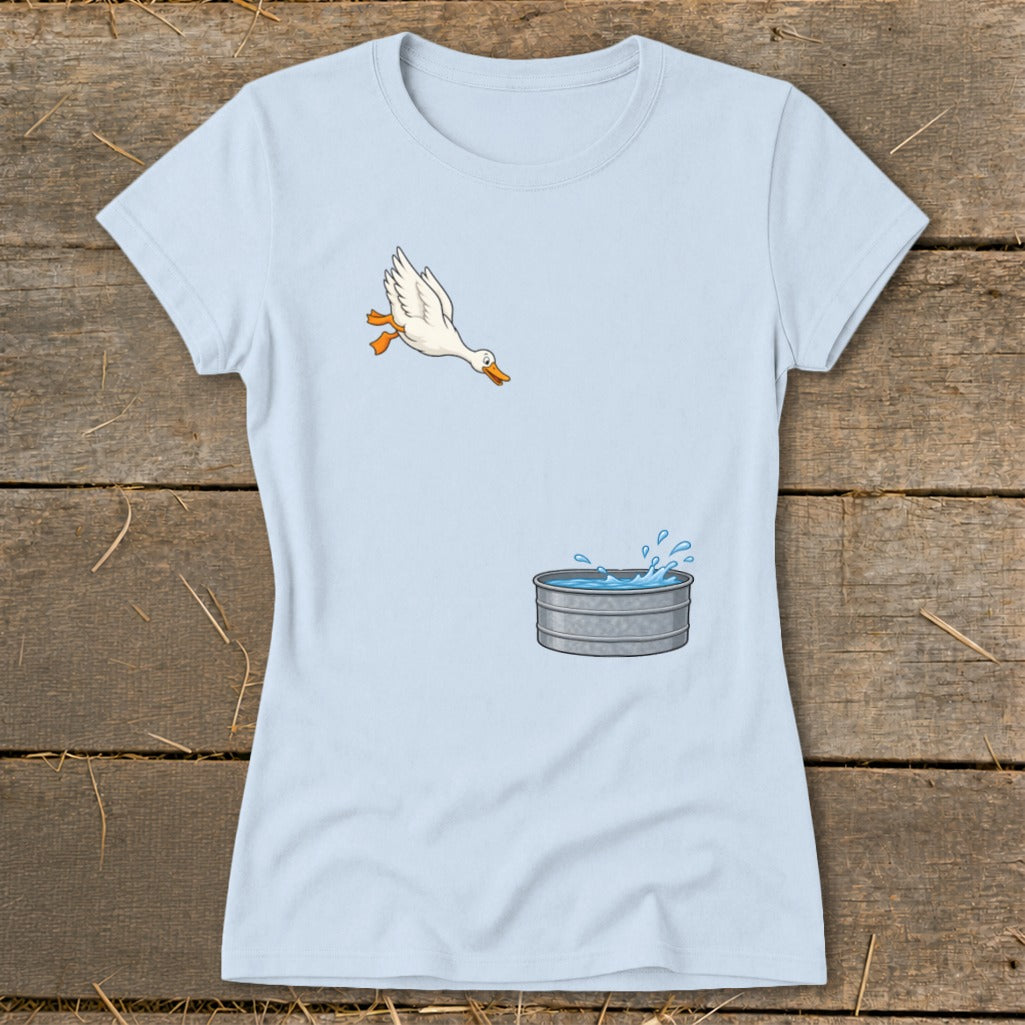 Light blue t-shirt with cartoon duck jumping into a galvanized water trough.