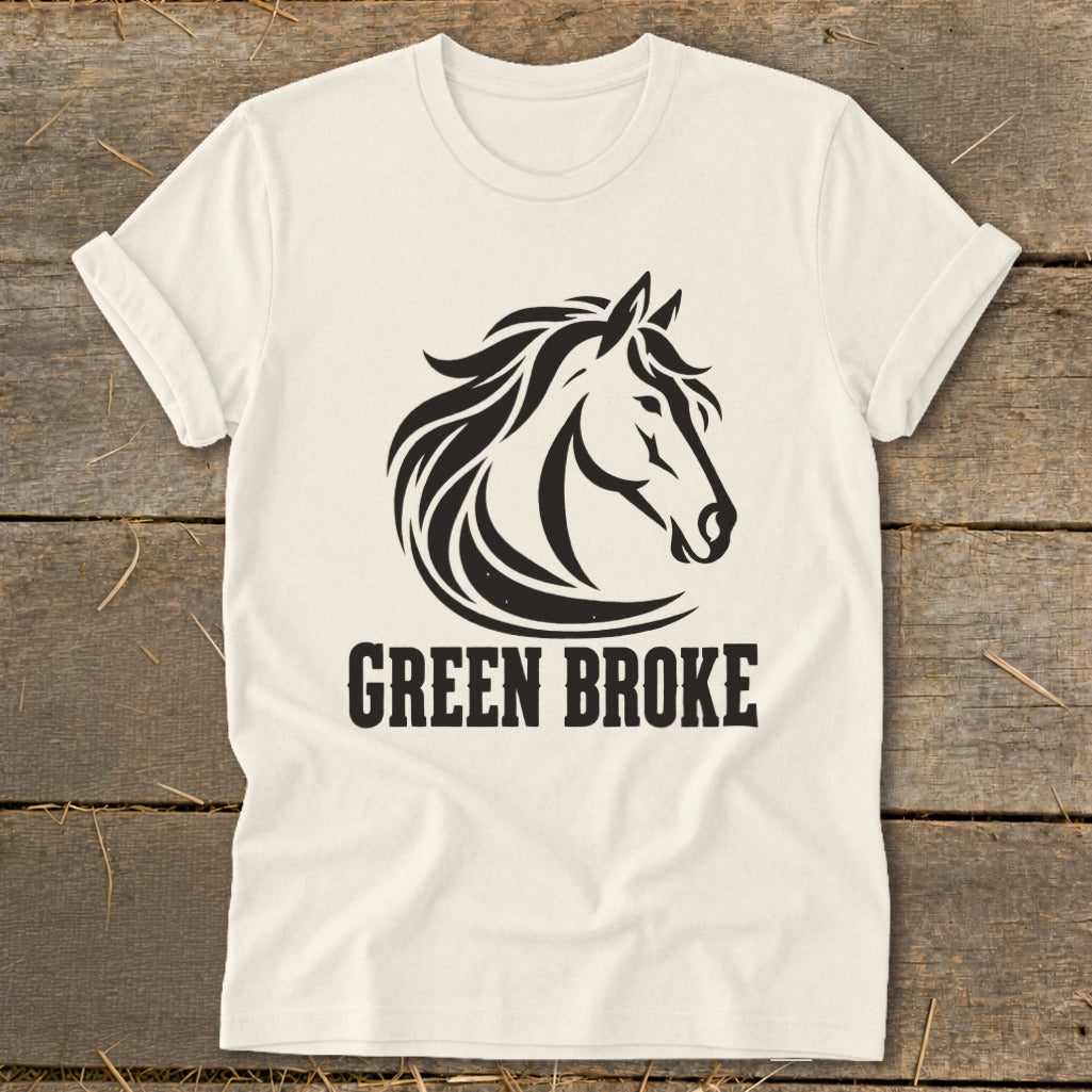 An off-white t-shirt featuring a black graphic of a horse head and the text GREEN BROKE.