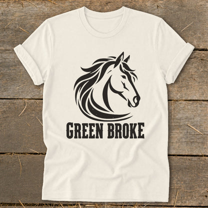 An off-white t-shirt featuring a black graphic of a horse head and the text GREEN BROKE.