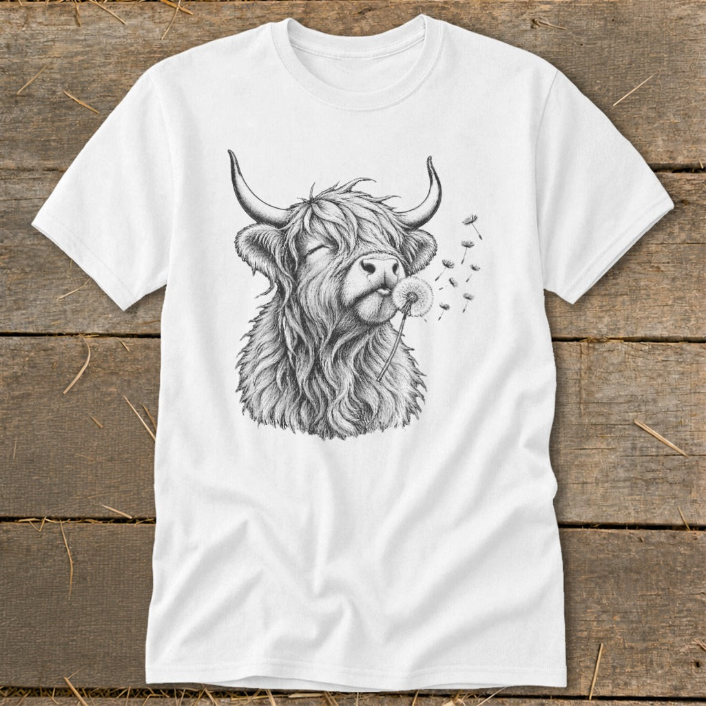 Highland cow with closed eyes blowing a dandelion on a white t-shirt.