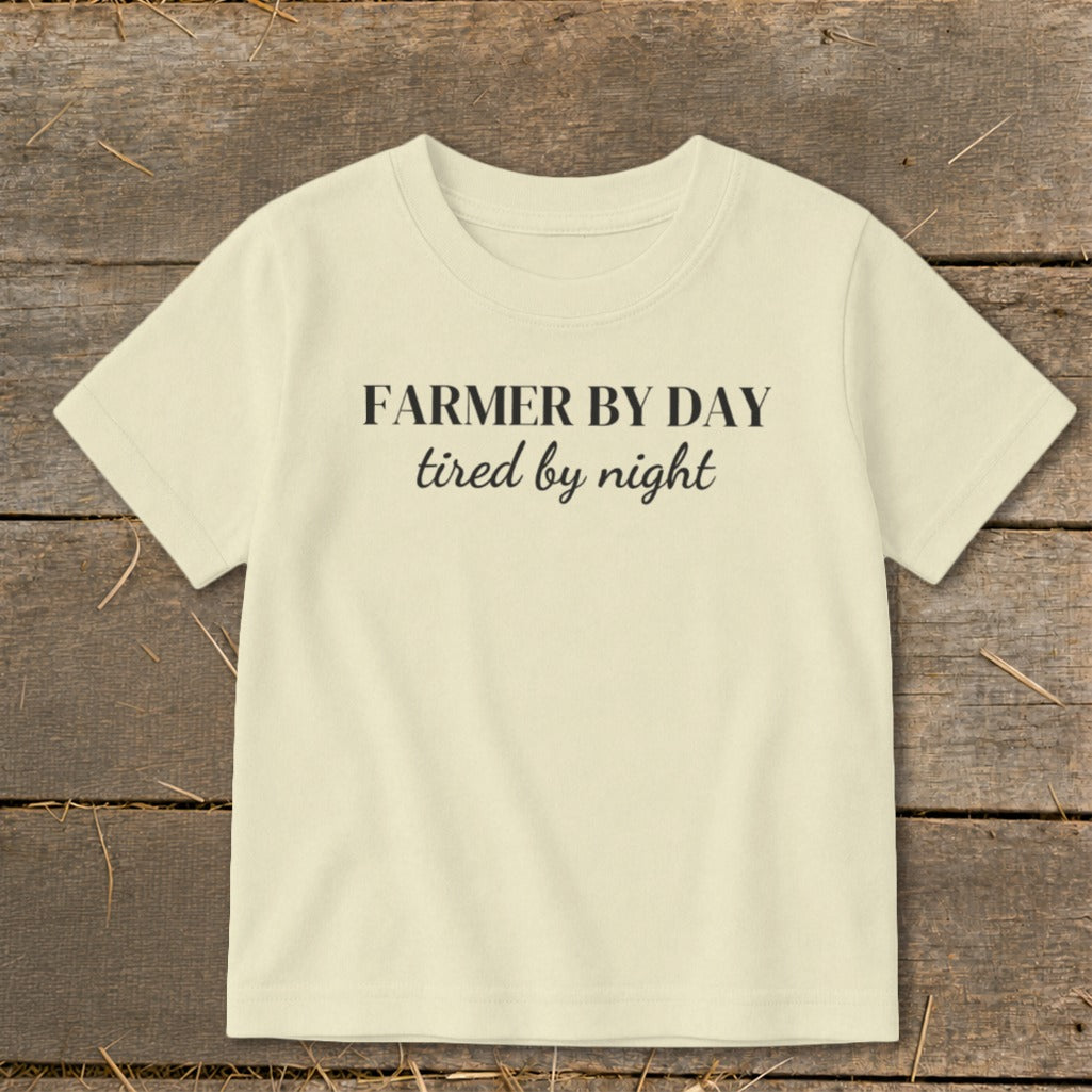 Cream t-shirt with black text reading "FARMER BY DAY tired by night".