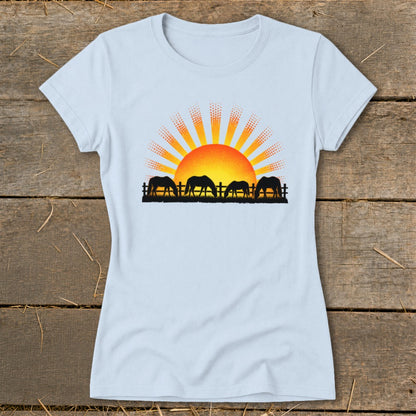 Four horses graze by a fence beneath a stylized sunrise graphic.