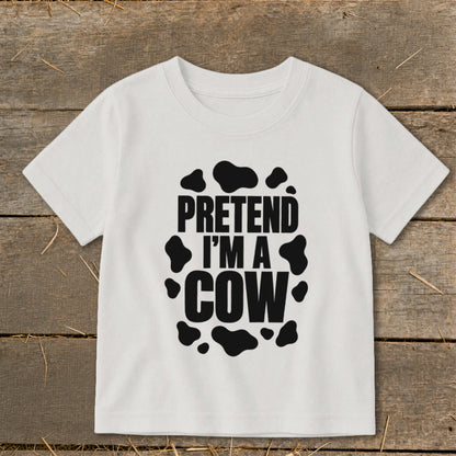 White t-shirt with black text "PRETEND I'M A COW" and cow spots.