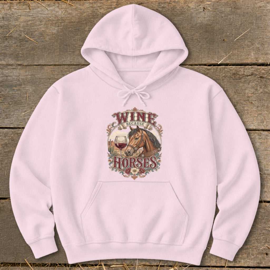 Pink hoodie with graphic of horse, wine glass, and text "Wine Because Horses".