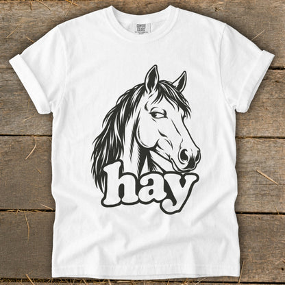 White t-shirt with a black line drawing of a horse's head and the word "hay".