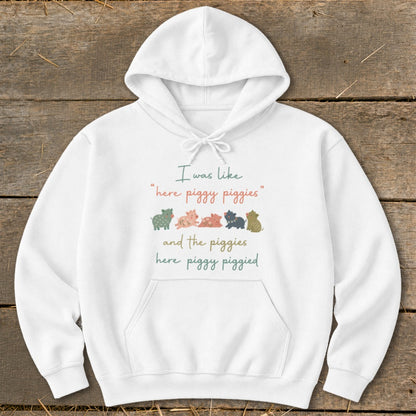 White hoodie with text and five cartoon pigs.